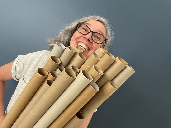 A picture of the author holding 20 cardboard rolls