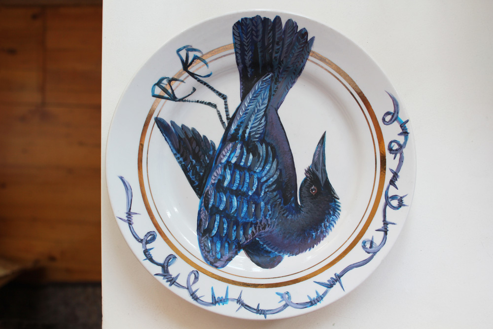 The image of a crow painted onto a plate