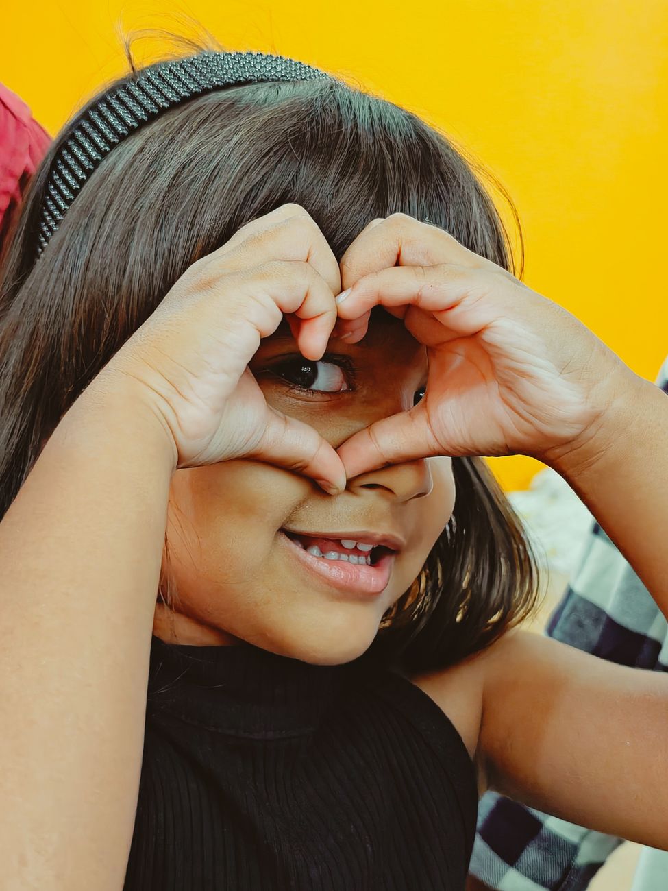 happy child making heart shape with hands